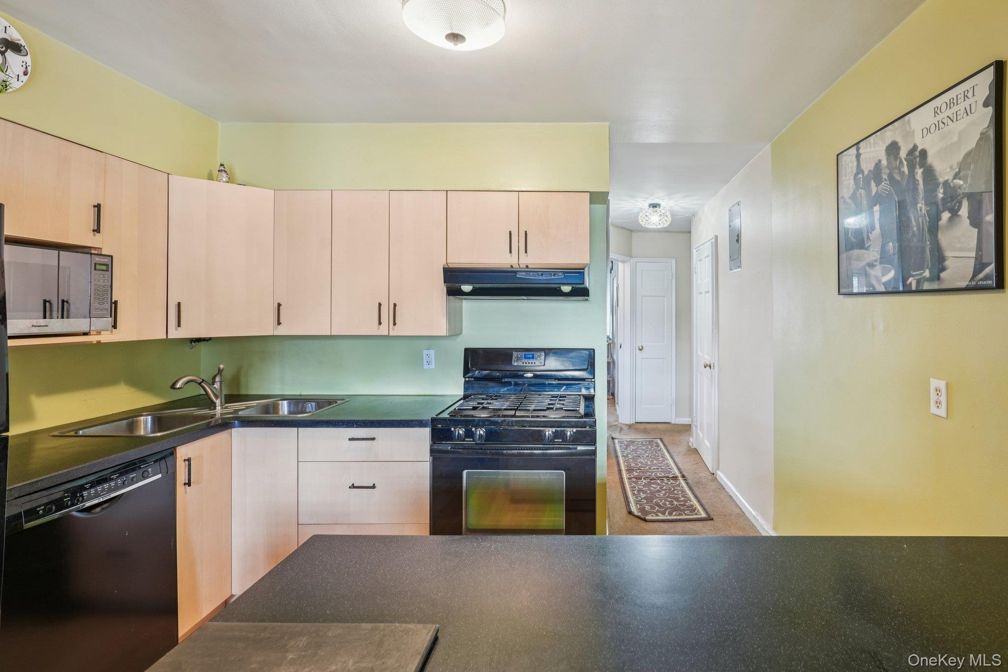 57 Maple Avenue, Unit 2B Hastings-on-Hudson, NY 10706 - Photo 18 of 38 a kitchen with granite countertop a stove a sink and a refrigerator