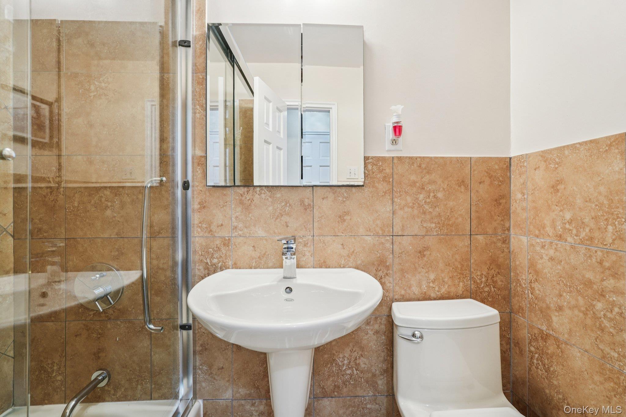 57 Maple Avenue, Unit 2B Hastings-on-Hudson, NY 10706 - Photo 19 of 38 a bathroom with a sink a toilet and shower