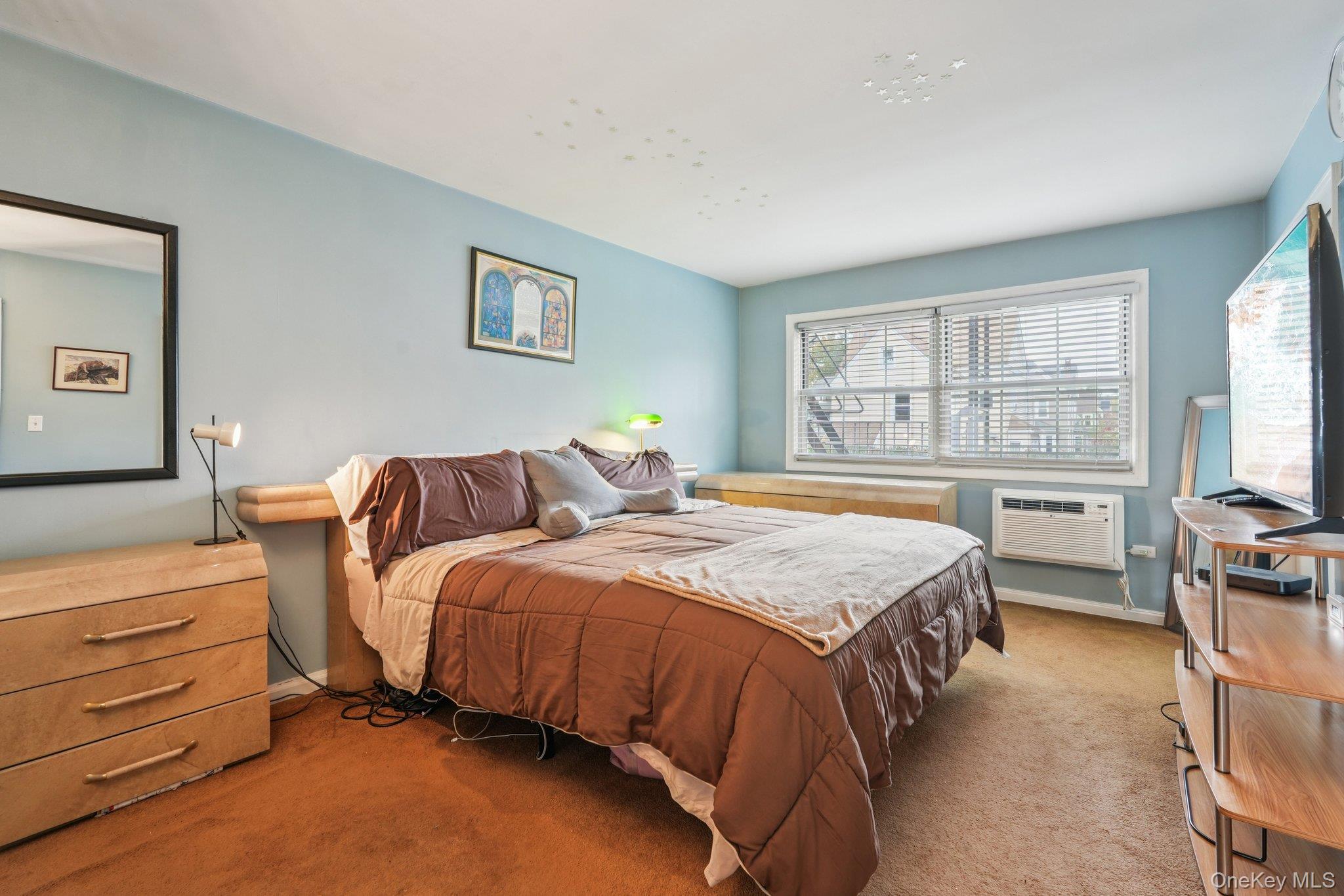 57 Maple Avenue, Unit 2B Hastings-on-Hudson, NY 10706 - Photo 20 of 38 a bed sitting in a bedroom next to a window with a dresser