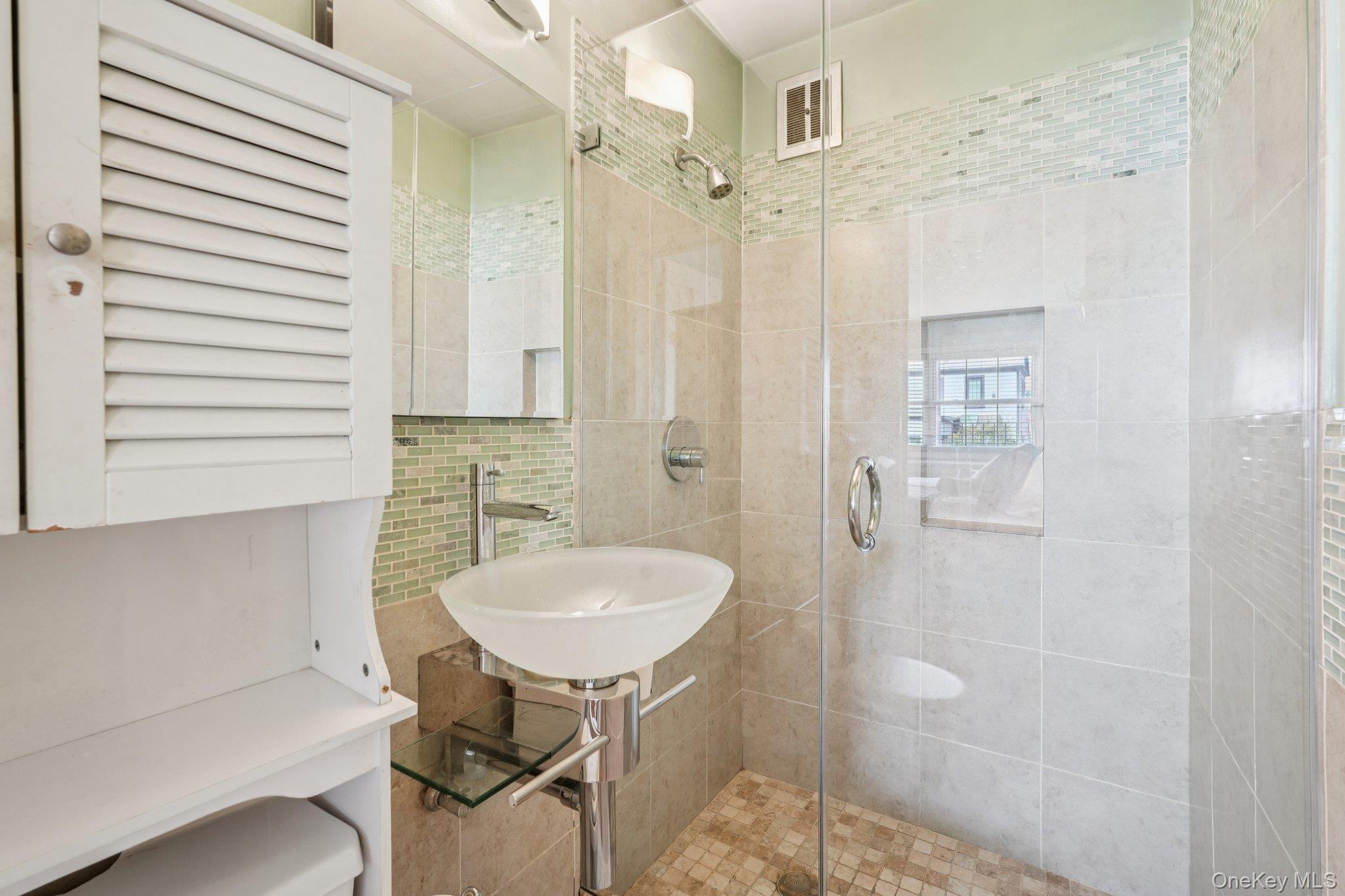 57 Maple Avenue, Unit 2B Hastings-on-Hudson, NY 10706 - Photo 23 of 38 a bathroom with a sink and a mirror