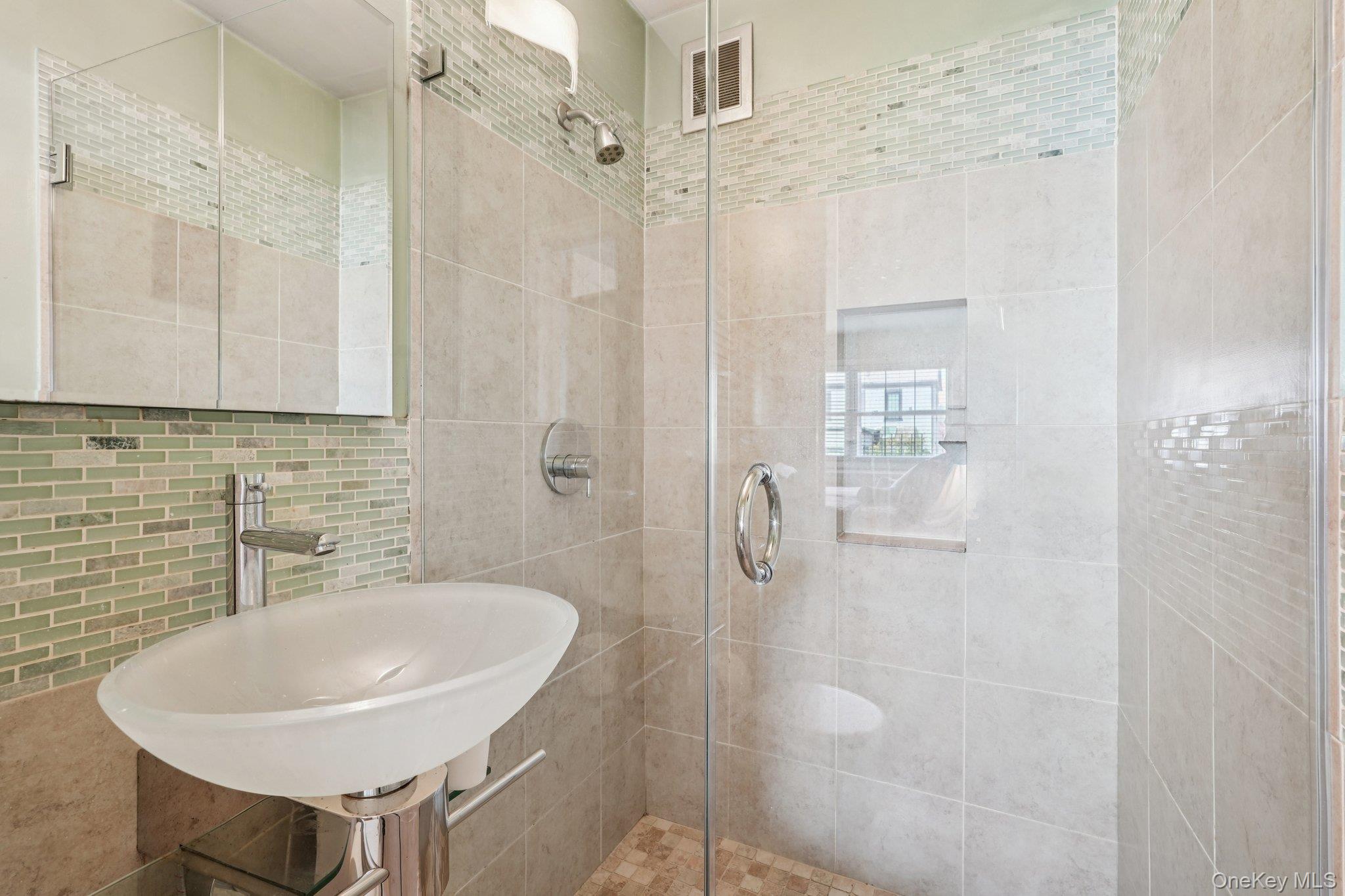 57 Maple Avenue, Unit 2B Hastings-on-Hudson, NY 10706 - Photo 24 of 38 a bathroom with a sink a shower and a mirror