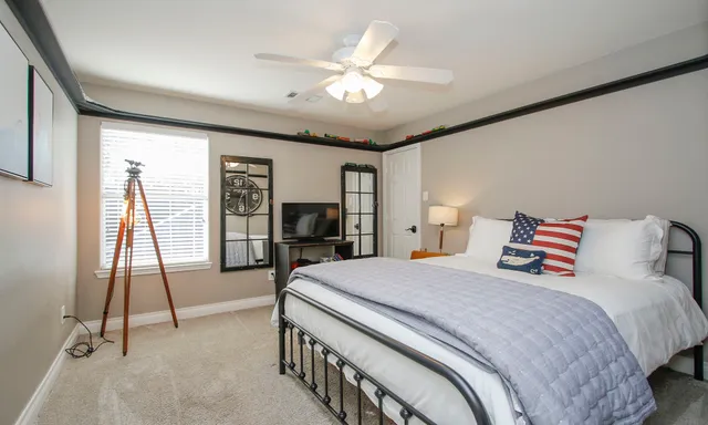 a bedroom with a bed and a chandelier
