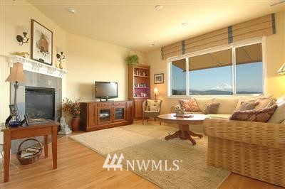 25527 Southeast 275th Place Maple Valley, WA 98038 - Photo 2 of 20 a bedroom with furniture and a flat screen tv