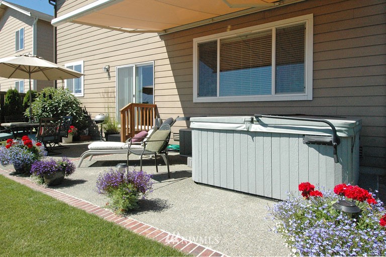25527 Southeast 275th Place Maple Valley, WA 98038 - Photo 15 of 20 a view of a chair and table in the back yard of the house