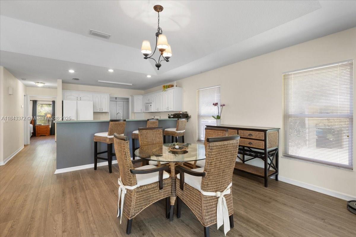 2159 Northwest 82nd Terrace Bell, FL 32619 - Photo 31 of 48 a view of a dining room with furniture window and wooden floor