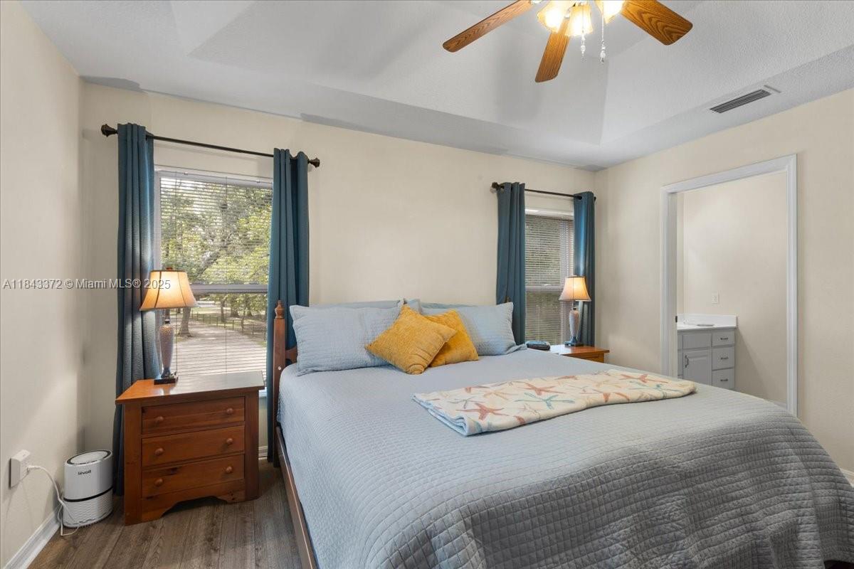 2159 Northwest 82nd Terrace Bell, FL 32619 - Photo 36 of 48 a bedroom with a bed and wooden floor