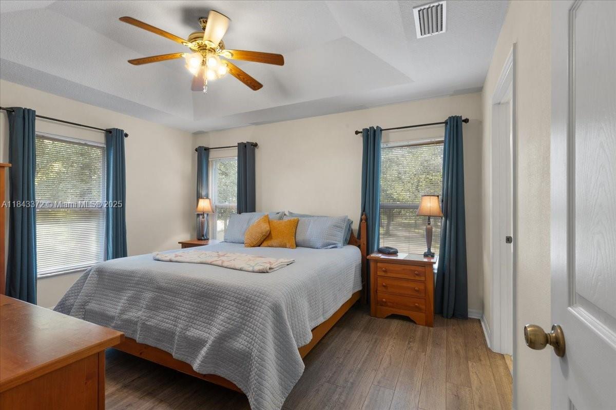 2159 Northwest 82nd Terrace Bell, FL 32619 - Photo 37 of 48 a bedroom with a bed and a chandelier