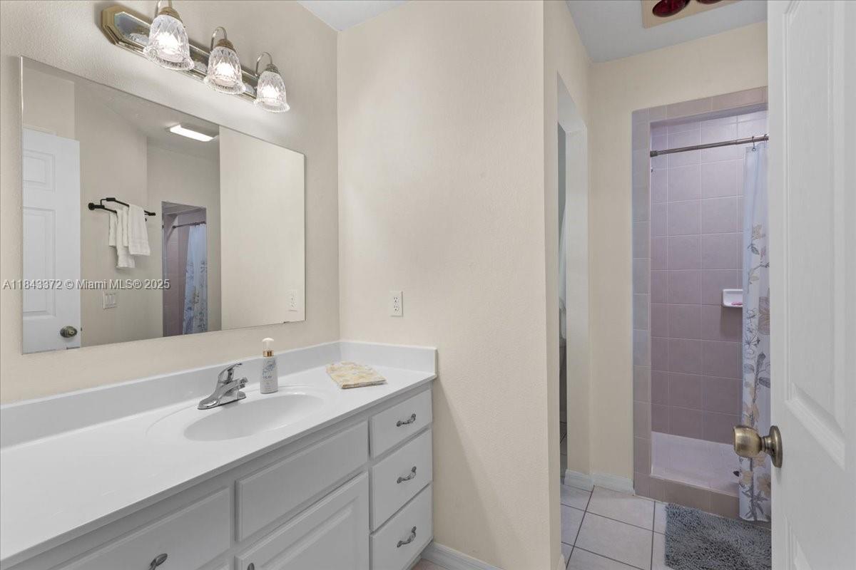 2159 Northwest 82nd Terrace Bell, FL 32619 - Photo 38 of 48 a bathroom with a double vanity sink mirror and shower