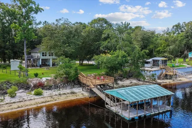 a view of a house with backyard and sitting area