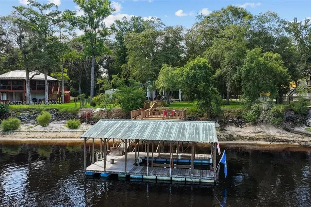 a view of backyard with swimming pool and outdoor seating