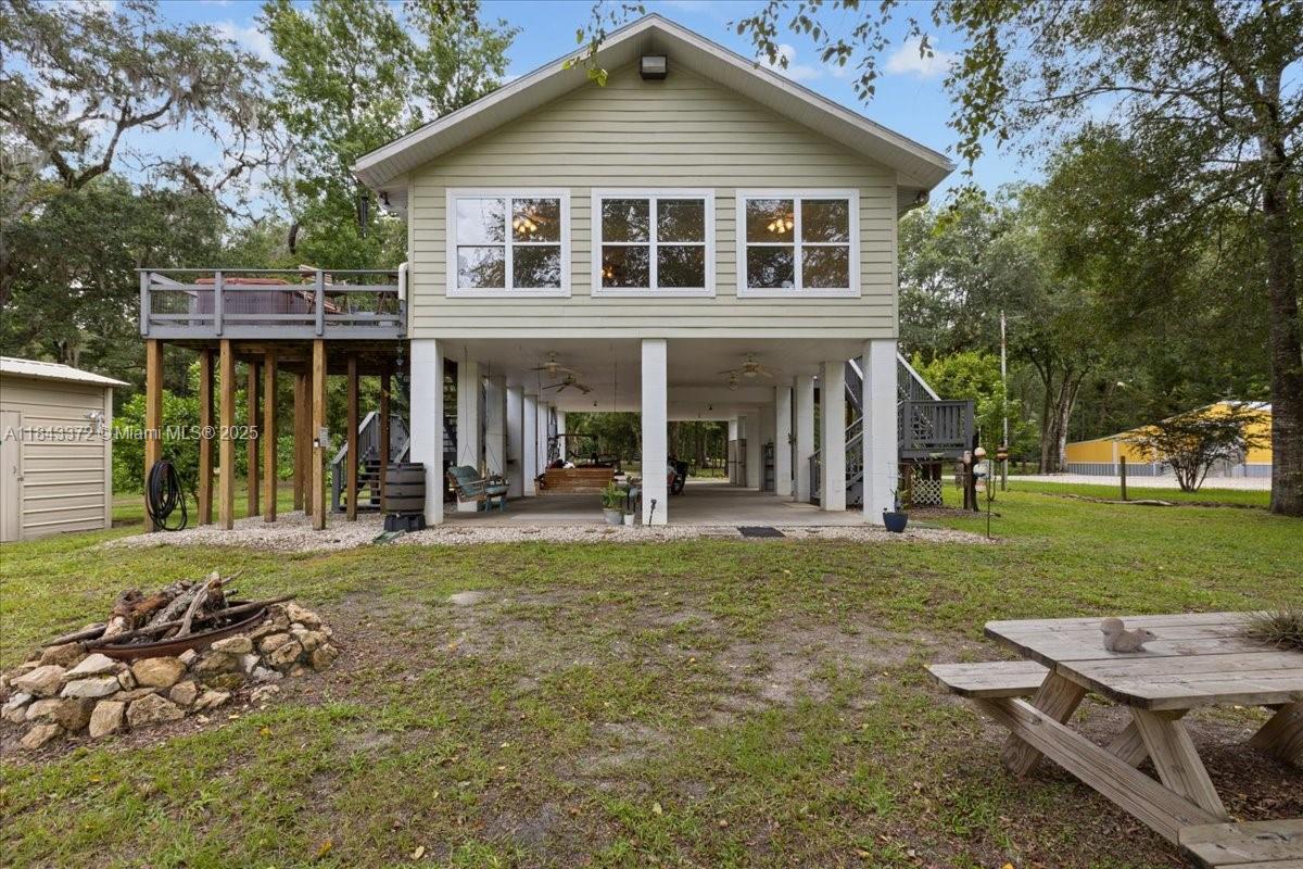 2159 Northwest 82nd Terrace Bell, FL 32619 - Photo 7 of 48 a front view of a house with a yard table and chairs