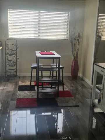 a living room with furniture a window and a flat screen tv