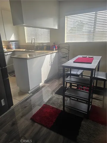 a kitchen with a sink cabinets and wooden floor