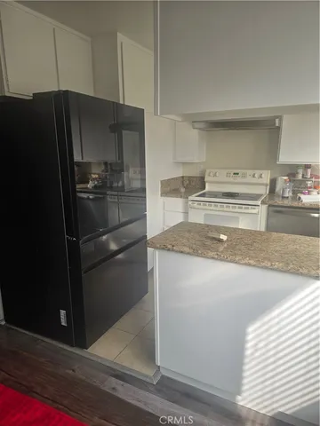 a kitchen with a refrigerator stove and cabinets