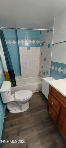 a bathroom with a sink a toilet and bathtub