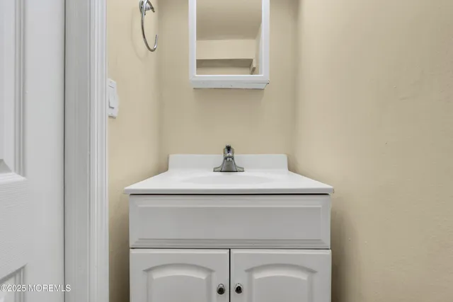 a bathroom with a sink a vanity and a mirror