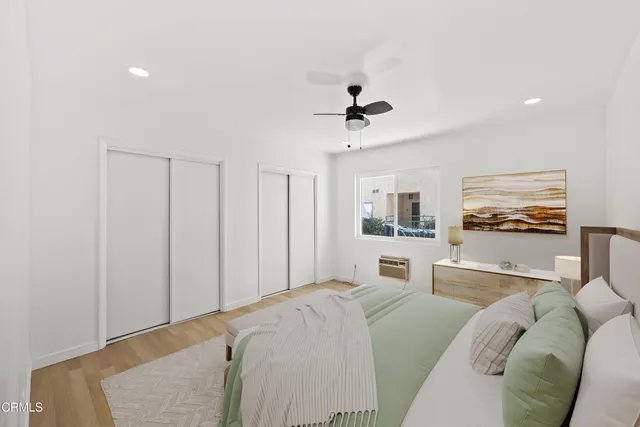 a bedroom with a bed and glass window