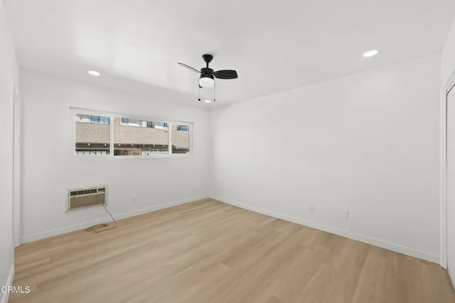 a view of a room with wooden floor and windows