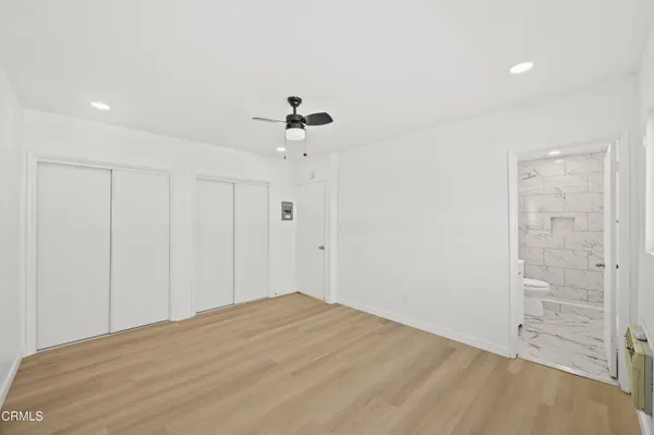 a view of a room has a bed and a chandelier