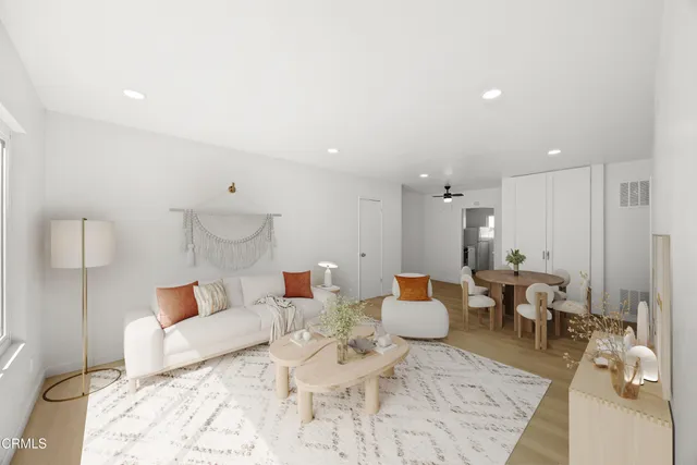 a living room with furniture and a wooden floor