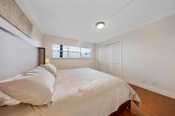 a bedroom with a bed and a large window