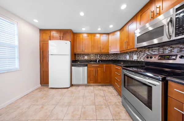 a kitchen with a sink cabinets and stainless steel appliances