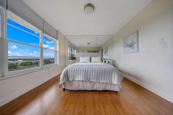 a bedroom with a large bed and a large window