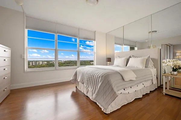 a bedroom with a bed and a large window