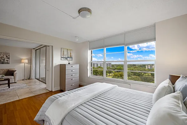 a bedroom with a large bed and a large window