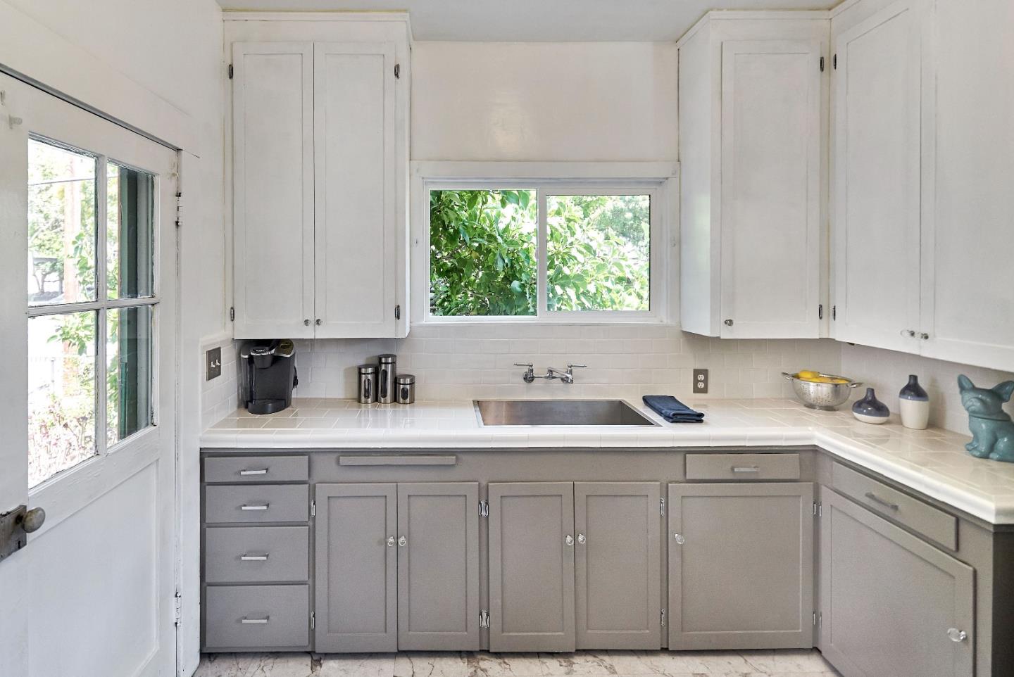 205 View Street Mountain View, CA 94041 - Photo 12 of 30 a kitchen with white cabinets and window