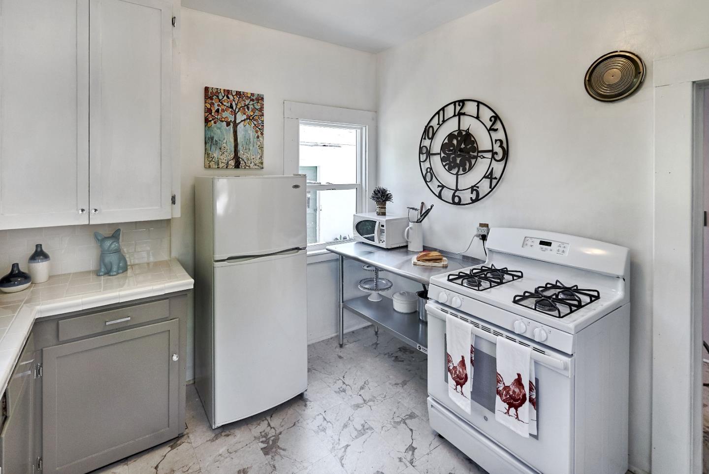205 View Street Mountain View, CA 94041 - Photo 14 of 30 a kitchen with a refrigerator and a stove