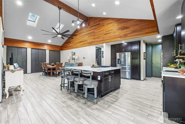 a large room with stainless steel appliances kitchen island granite countertop a large counter top