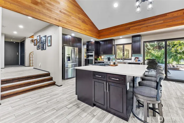 a kitchen with a sink appliances and a large window