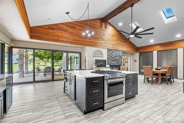 a kitchen with stainless steel appliances granite countertop a stove and a refrigerator