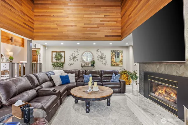 a living room with furniture a fireplace and a dining table