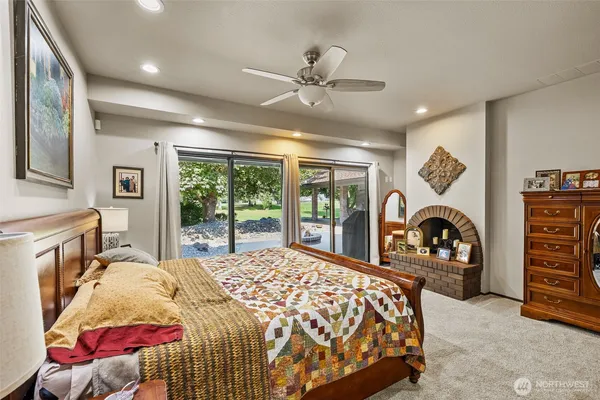 a bedroom with a bed and a large window
