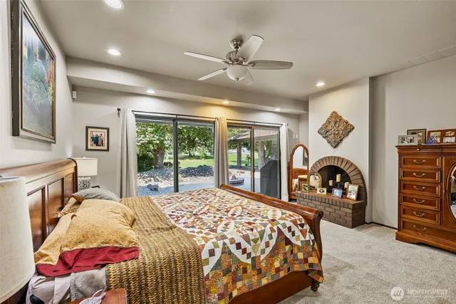 a bedroom with a bed and a large window