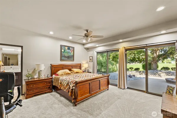 a bedroom with a bed and a large window