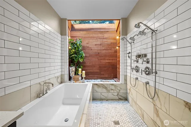 a bathroom with a bathtub and shower