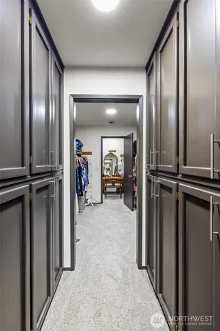 a bedroom with a bed and a large mirror