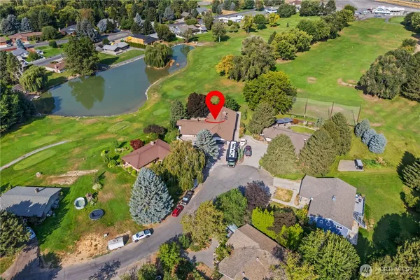 an aerial view of a house with a yard and lake view