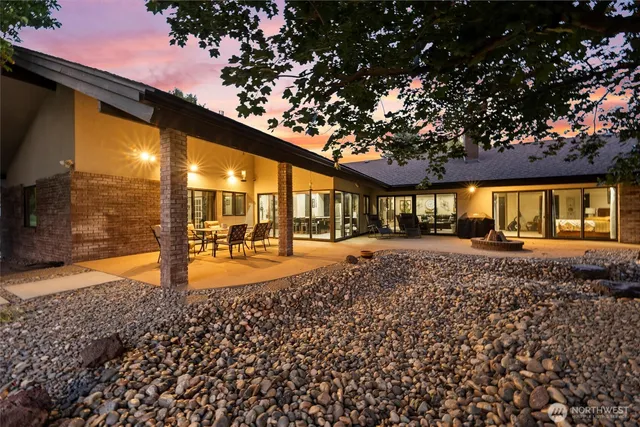 a view of a house with backyard and sitting area