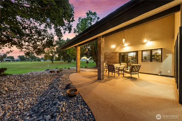 a view of a house with backyard porch and sitting area