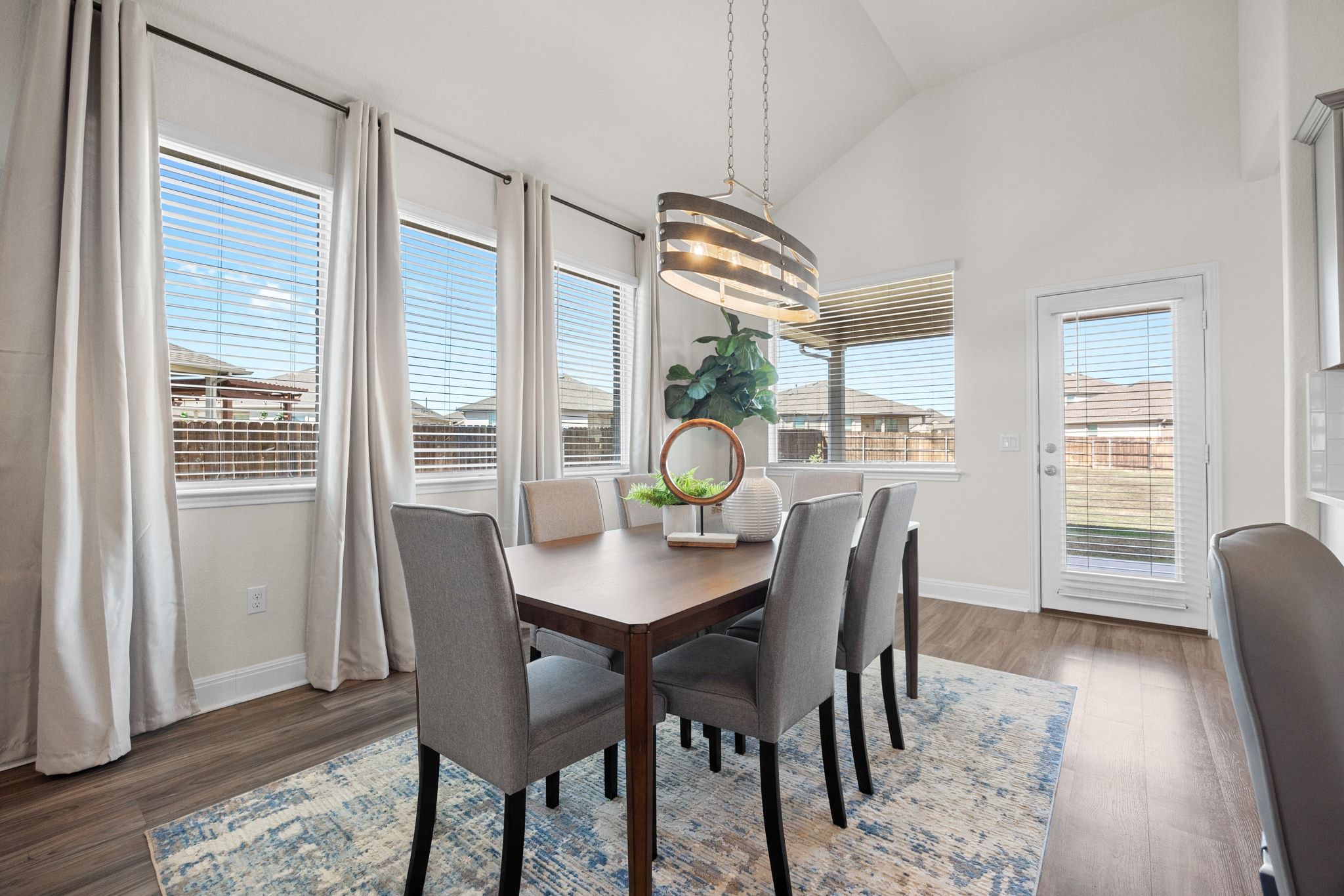 16804 Guido Cove Pflugerville, TX 78660 - Photo 11 of 38 Dining area with lofted ceiling and dark wood-style flooring