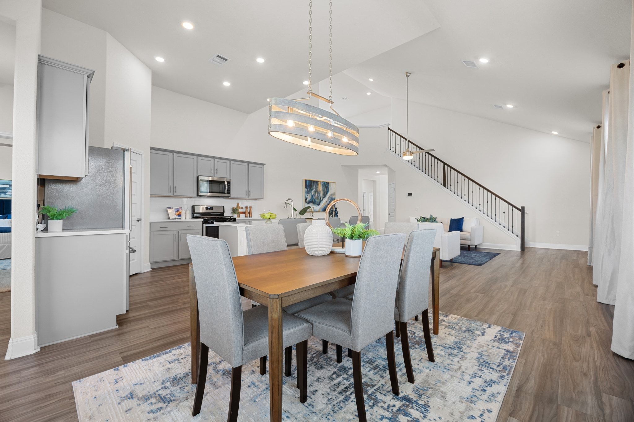 16804 Guido Cove Pflugerville, TX 78660 - Photo 12 of 38 Dining space with high vaulted ceiling, stairs, light wood finished floors, and recessed lighting