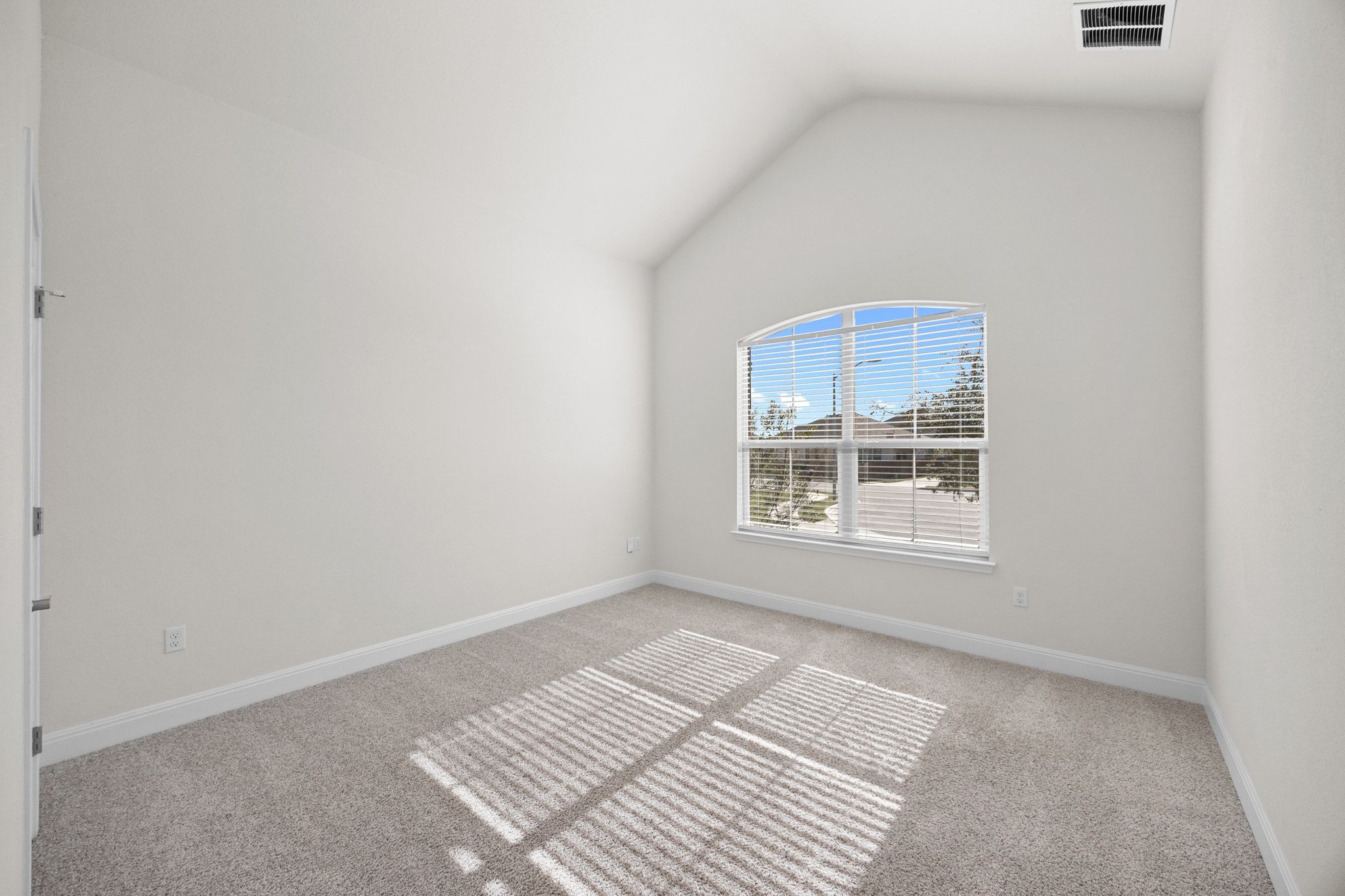 16804 Guido Cove Pflugerville, TX 78660 - Photo 18 of 38 Carpeted spare room featuring vaulted ceiling and baseboards