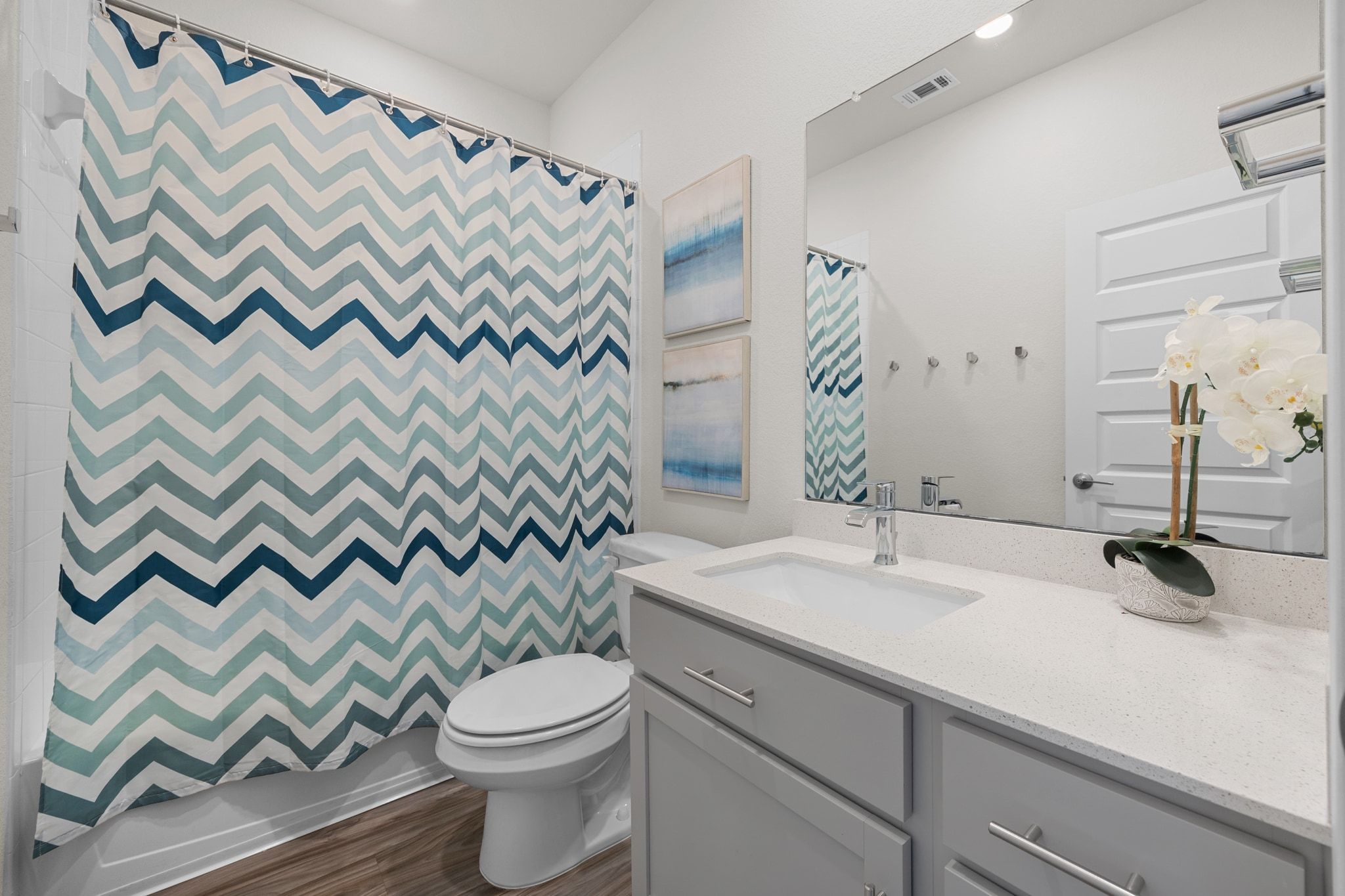 16804 Guido Cove Pflugerville, TX 78660 - Photo 23 of 38 Bathroom with vanity, dark wood-style flooring, recessed lighting, and shower / bath combination with curtain
