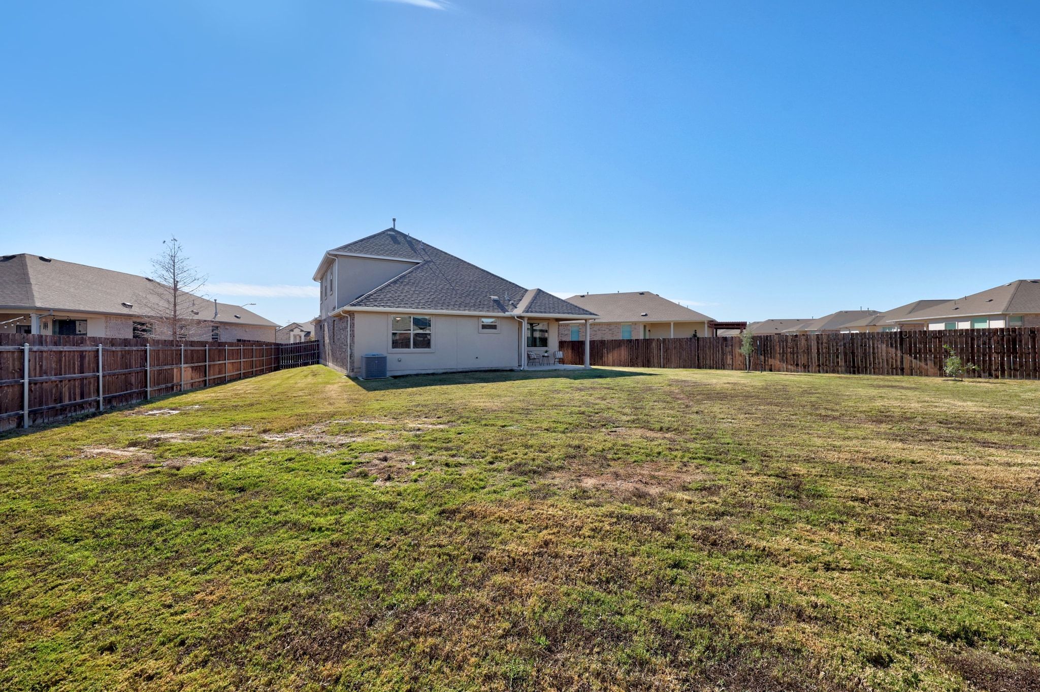 16804 Guido Cove Pflugerville, TX 78660 - Photo 30 of 38 Rear view of house featuring a residential view, a patio, and a fenced backyard