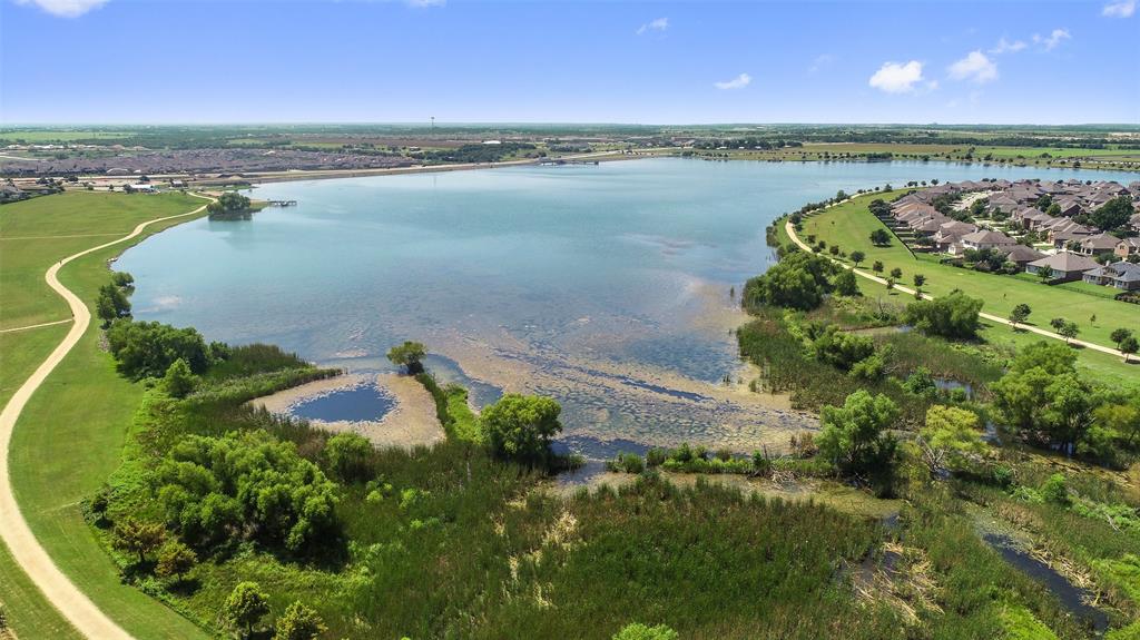 16804 Guido Cove Pflugerville, TX 78660 - Photo 36 of 38 Aerial view of property and surrounding area with a large body of water