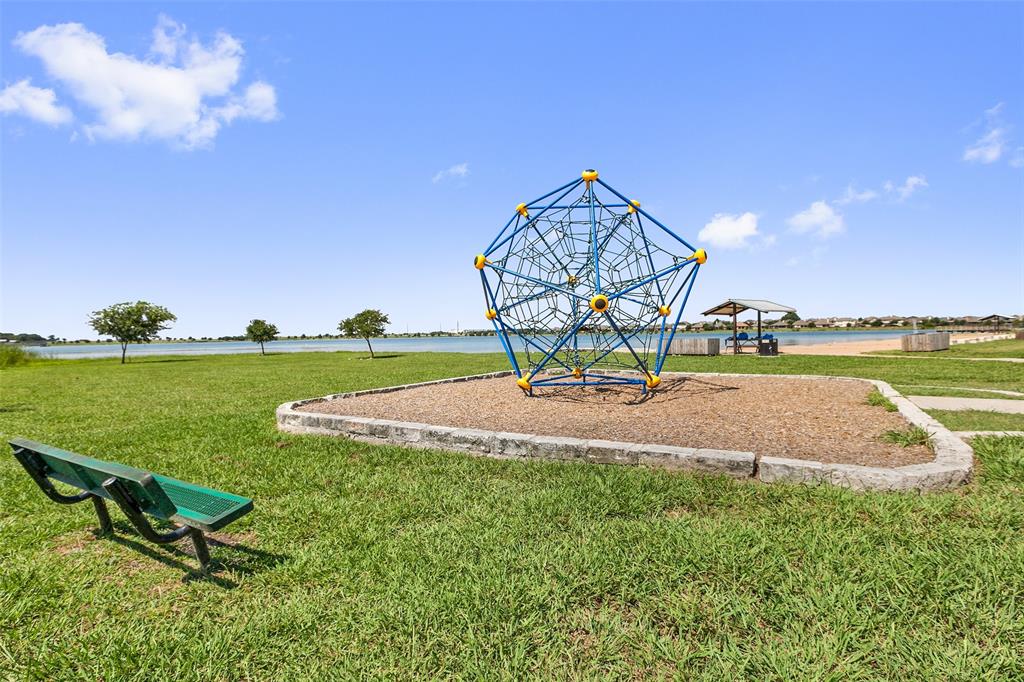 16804 Guido Cove Pflugerville, TX 78660 - Photo 37 of 38 Community playground featuring a lawn
